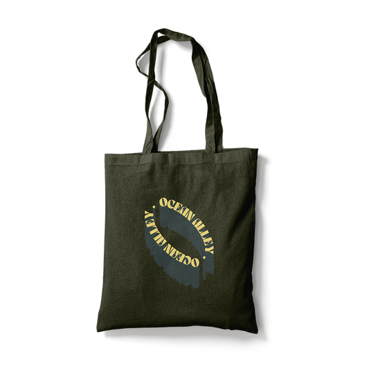 Dark green canvas tote bag with yellow text from Ocean Alley Black Tote collection